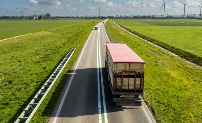 brown wooden house on green grass field under blue sky during daytime